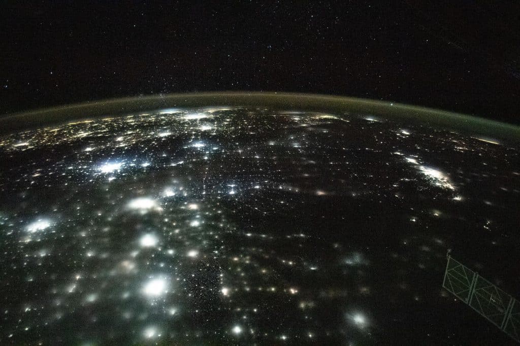 City lights across North America at night under Earth's airglow, photographed from the International Space Station
